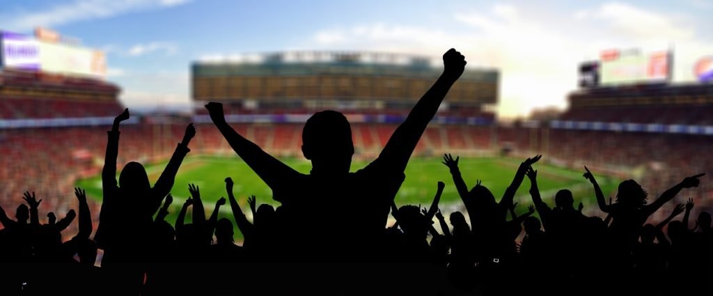 Fans cheering at a football stadium