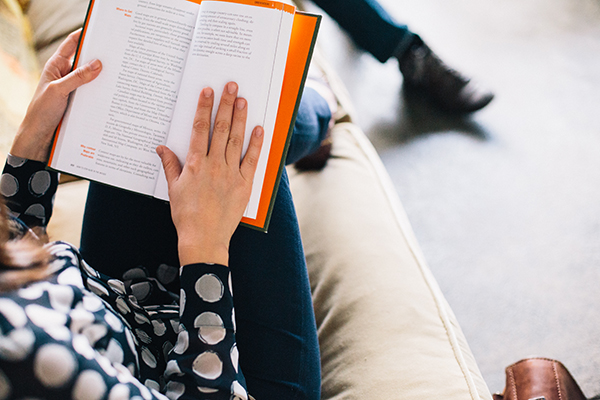 Person on couch reading