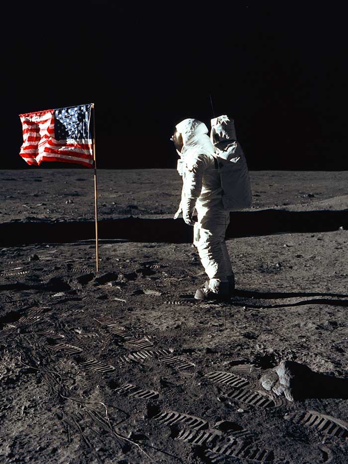 Buzz Aldrin plants the flag on the moon during the Apollo 11 mission.