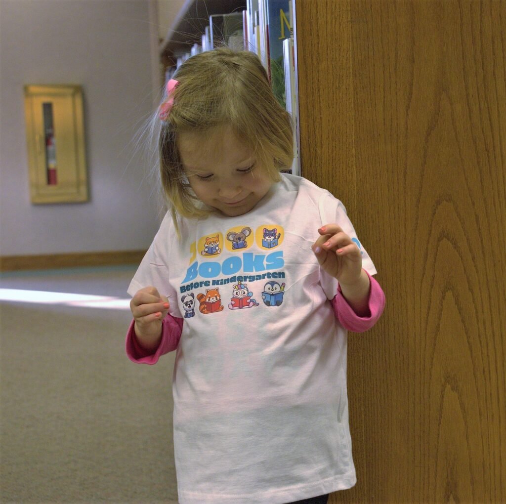 Little girl admiring her shirt